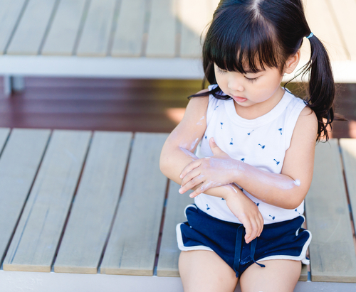 Adorable,Toddler,Girl,Putting,Solar,Cream,On,Arms,Hands,Smiling